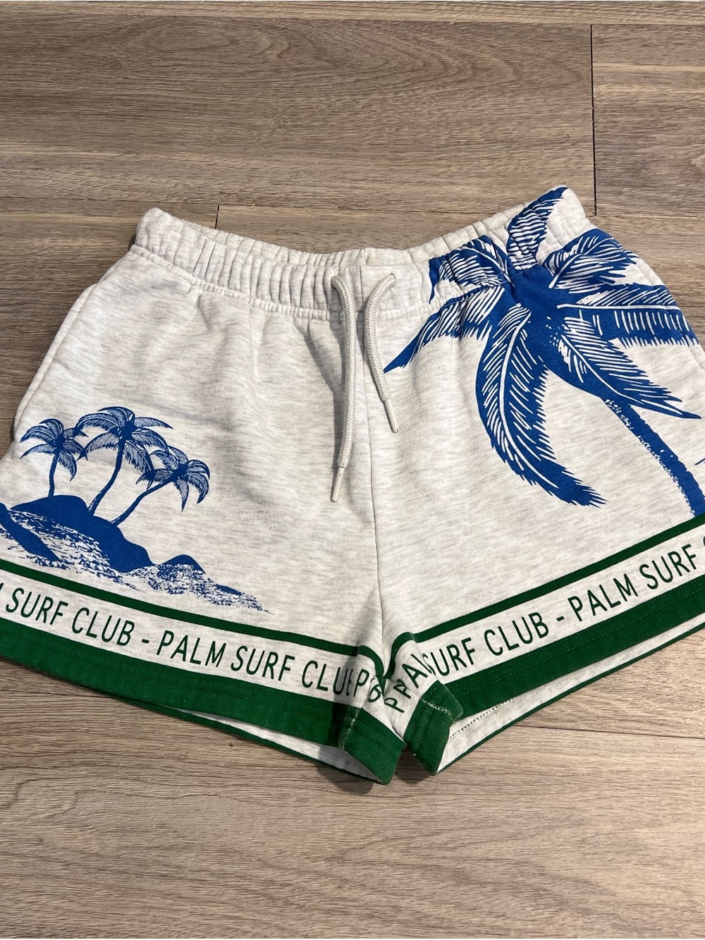 Vintage Cream Athletic Shorts with Blue Palm Graphic and Green Trim